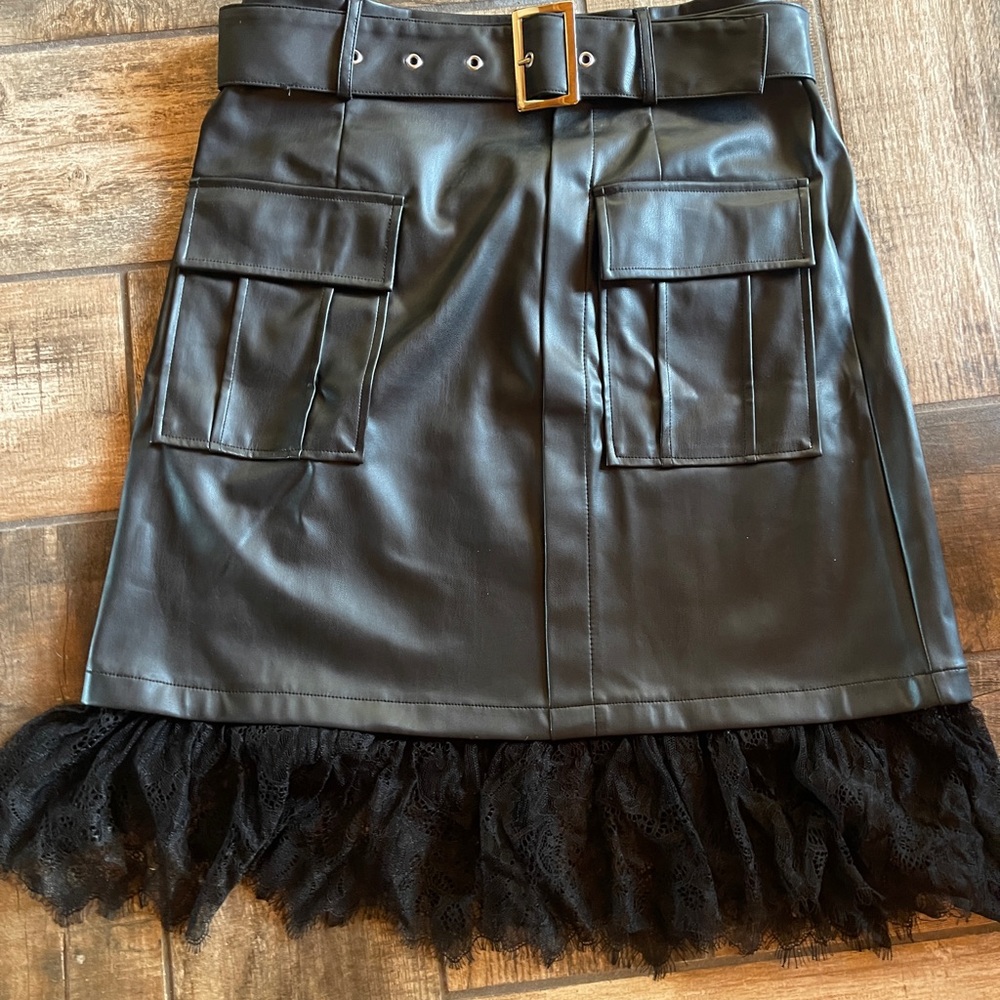 Venus NWOT black faux leather skirt with lace hem.